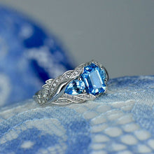 Load image into Gallery viewer, 3.0 Carat Blue Topaz 8x6mm Emerald Cut Center Stone and two Pear 6x4mm 2x0.5 Carat Wing Ring with 10K white Gold ring size 9