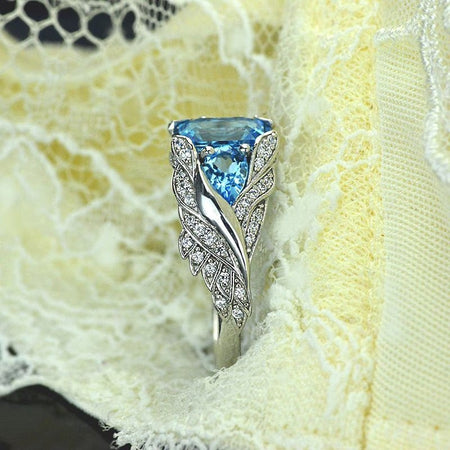 3.0 Carat Blue Topaz 8x6mm Emerald Cut Center Stone and two Pear 6x4mm 2x0.5 Carat Wing Ring with 10K white Gold ring size 9