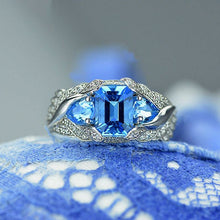 Load image into Gallery viewer, 3.0 Carat Blue Topaz 8x6mm Emerald Cut Center Stone and two Pear 6x4mm 2x0.5 Carat Wing Ring with 10K white Gold ring size 9
